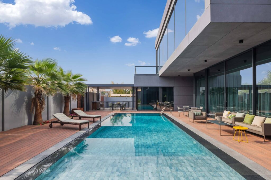 Residence A — pool terrace with timber decking and glazed living spaces, featured on ArchDaily