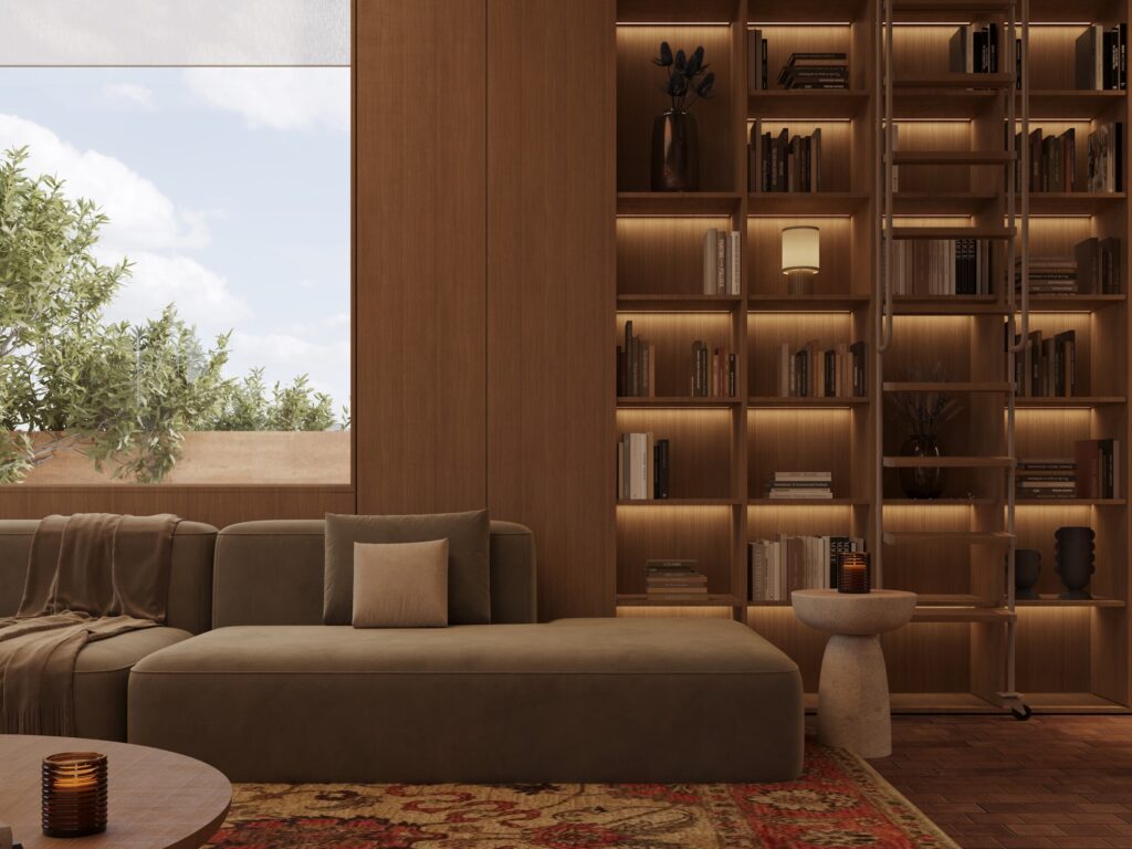 Library in Silent House, Dubai: lit oak bookshelves with a rolling ladder, a low sofa and a window onto the garden. Interior design by IAIA.